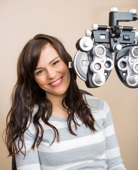 Smiling brunette woman at an eye exam