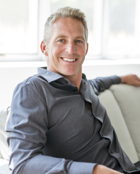Smiling middle age man sitting on a couch
