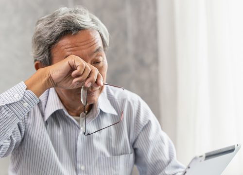 Asian elderly eye irritation problem fatigue and tired from hard work or computer vision syndrome