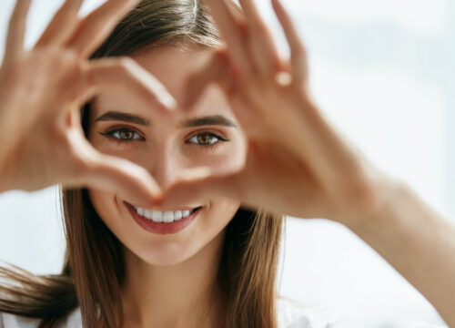 Photo of a woman making a heart shape with her hands