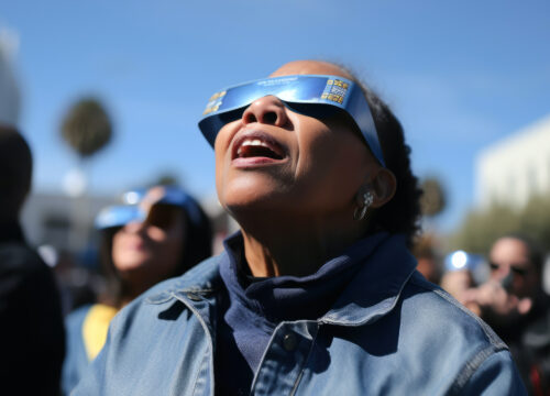 Photo of a woman looking up a solar eclipse