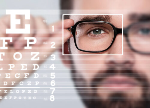Photo of a man with glasses taking an eye test